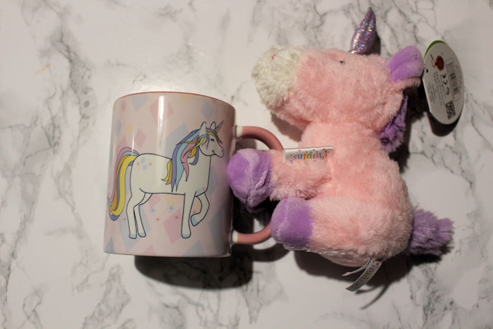 Unicorn teddy holding unicorn side of mug