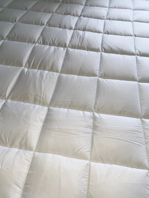 Mattress topper on bed