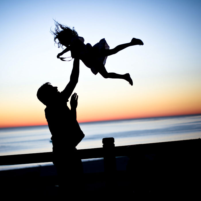 silhouette man throwing girl in air kids self confidence