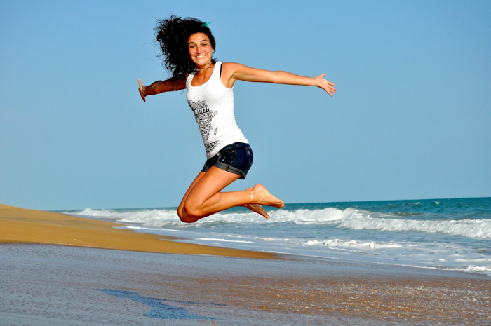 Woman jumping on beach fitness