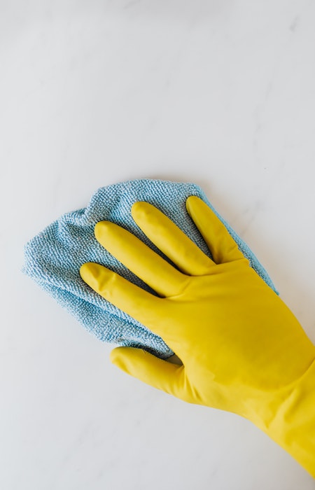 housework yellow rubber gloves and blue cloth