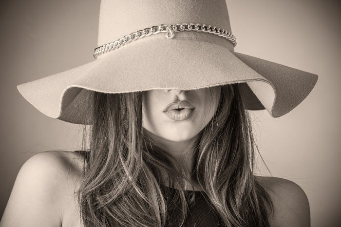 winter fashion woman in large brim hat sepia