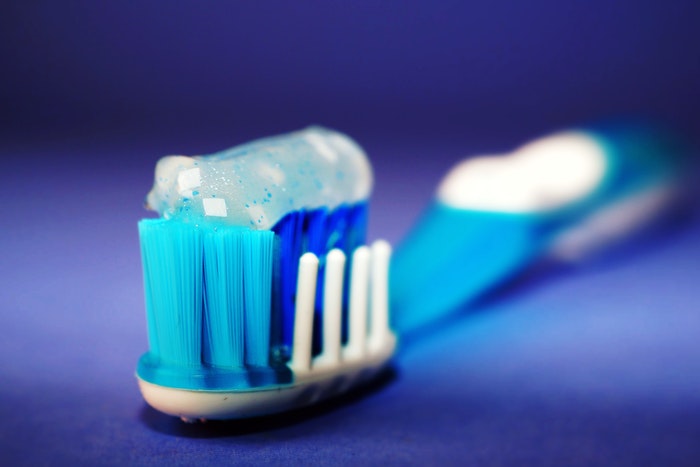 Blue Toothbrush, toothpaste, blue background, tooth knocked out