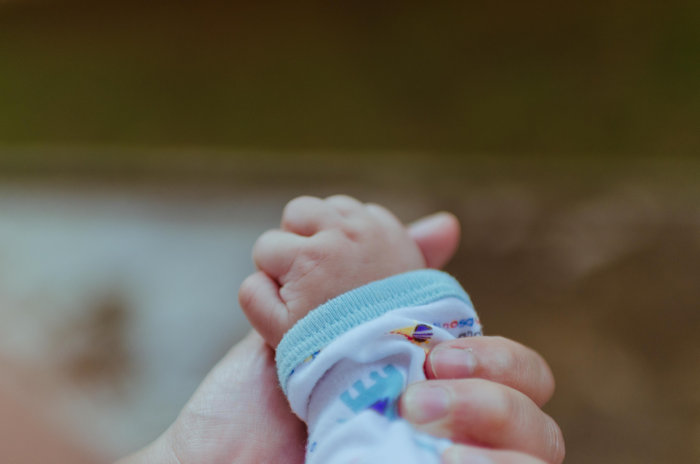 baby hand, maternity and paternity leave